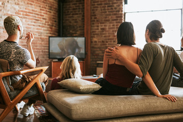 Friends watching television together