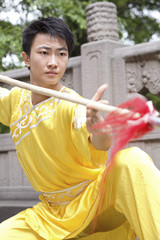 Man practising martial arts with chinese spear