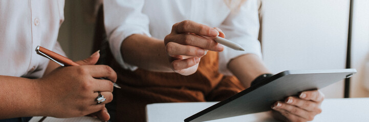 Wall Mural - Business people working with a digital tablet in a meeting