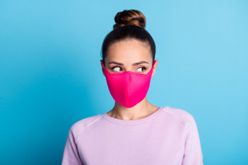  Portrait photo of pretty lady keep social distance citizen look side empty space interested see handsome guy sympathizing wear protect bright face mask sweater isolated blue color background