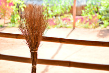 Close-up Of Broom Leaning On Railing