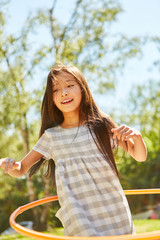 Wall Mural - Girl in child gymnastics with hoops