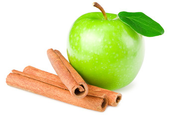 green apples with green leaves and cinnamon isolated on white background