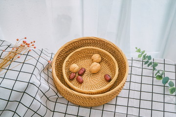 Wall Mural - Woven bamboo baskets with dried fruit and other food on the tablecloth