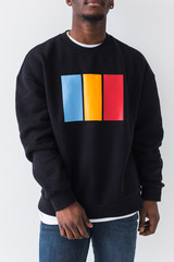 Wall Mural - Handsome African American man posing in black sweatshirt on a white background, close-up. Youth street fashion photo with afro hairstyle.