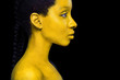 © Mike Orlov - Woman with black body paint. Cheerful young african girl with art bodypaint. An amazing model with yellow makeup. Closeup face.