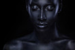© Mike Orlov - Woman with black body paint. Cheerful young african girl with bodypaint. An amazing model with art makeup. Closeup face.