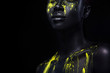 © Mike Orlov - Woman with black body paint. Cheerful young african girl with art bodypaint. An amazing model with yellow makeup. Closeup face.
