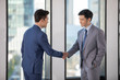 © Blue Jean Images - Successful businessmen shaking hands