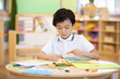 © Blue Jean Images - Little boy painting in classroom