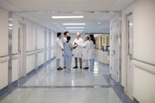 Doctors Talking In Hospital Corridor