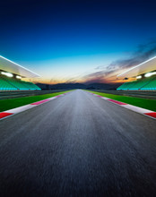 Diminishing Perspective Of Empty Motor Racing Track Against Sky During Sunset