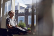 © Westend61 - Mature man sitting at the window at home with closed eyes