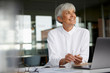 © Westend61 - Portrait of smiling senior businesswoman at desk in her office