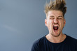 © Westend61 - Portrait of a screaming man with tousled hair