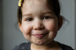 © Westend61 - Portrait of smiling little girl with brown eyes