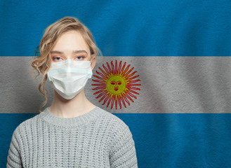 Wall Mural - Young woman wearing a face mask with national flag Argentina. Flu epidemic and virus protection concept