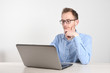 © Ivan - Man using laptop at home in living room. Mature businessman send email and working at home.Work at home. Typing on computer with paperworks and documents on table.