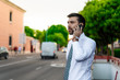 © tavi004 - Young business man with white shirt and tie in outdoor city making a phone call