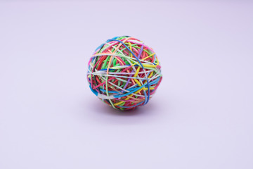 multi colored rubber band against white background