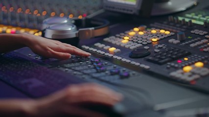 Poster - Audio Engineer, Musician, Artist Works in the Music Record Studio, Control Desk Mixer. Female Hands Moving Faders, Switchers, Buttons, Faders, Sliders to Broadcast, Record, Play Hit Song. Close-up 