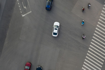 Aerial view of cars and motorcycles driving on city road top view