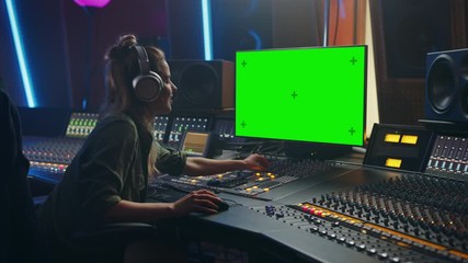 Poster - Stylish Female Audio Engineer / Producer Working in Music Record Studio, Uses Headphones, Green Screen Computer Display, Mixer Board, Control Desk to Create New Song. Creative Artist Musician. Zoom in