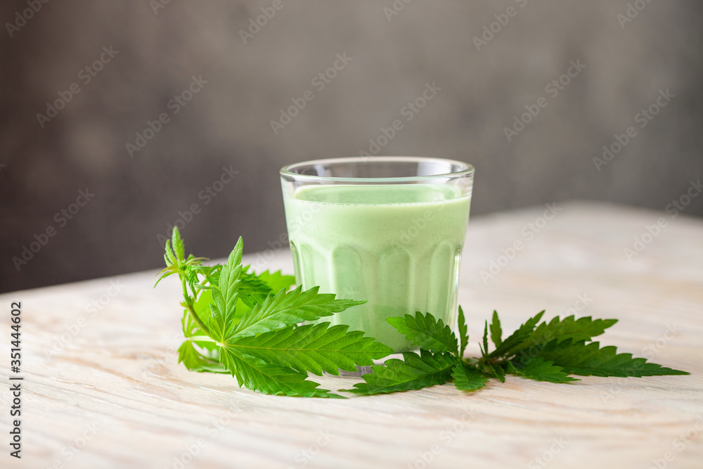 Cannabis herbal vegan gluten free lactose free milk and cannabis leaves. - obrazy, fototapety, plakaty 