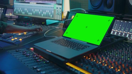 Poster - Modern Music Record Studio Control Desk with Green Screen Chroma Key Laptop, Equalizer, Mixer and other Professional Equipment. Switchers, Buttons, Faders, Sliders. Record, Play Songs. Close-up 