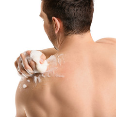 Poster - Handsome man taking shower against white background