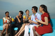 © ImageHit - Group of people chatting and laughing while having drinks