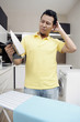 © ImageHit - Man scratching head while looking at iron
