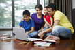 © ImageHit - Family using laptop together