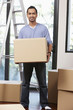 © ImageHit - Man carrying cardboard box