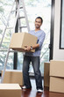 © ImageHit - Man carrying cardboard box