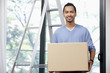 © ImageHit - Man carrying cardboard box