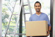 © ImageHit - Man carrying cardboard box