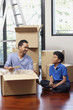 © ImageHit - Man and boy packing box together
