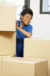 © ImageHit - Boy hiding behind cardboard boxes