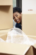© ImageHit - Boy hiding behind cardboard boxes