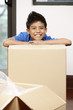 © ImageHit - Boy hiding behind cardboard boxes