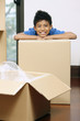 © ImageHit - Boy resting his head on cardboard box