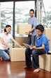 © ImageHit - Boy using digital tablet, man and woman packing in the background