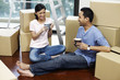 © ImageHit - Man and woman drinking coffee with cardboard boxes around