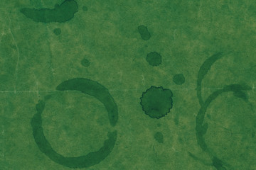 Wall Mural - Stains on a green paper textured background