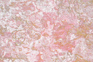 Wall Mural - grunge gold glitter on a pink textured background