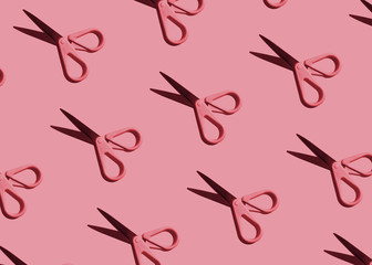 pink pattern: stationery scissors on pink background flat lay close-up. hard light.