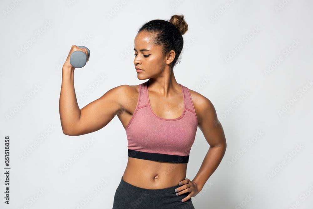 Fit woman working out with dumbbells - obrazy, fototapety, plakaty 