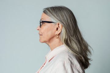 Wall Mural - Senior woman wearing eyeglasses in a profile shot