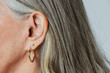 © rawpixel.com - Senior woman with pierced ears in a profile shot